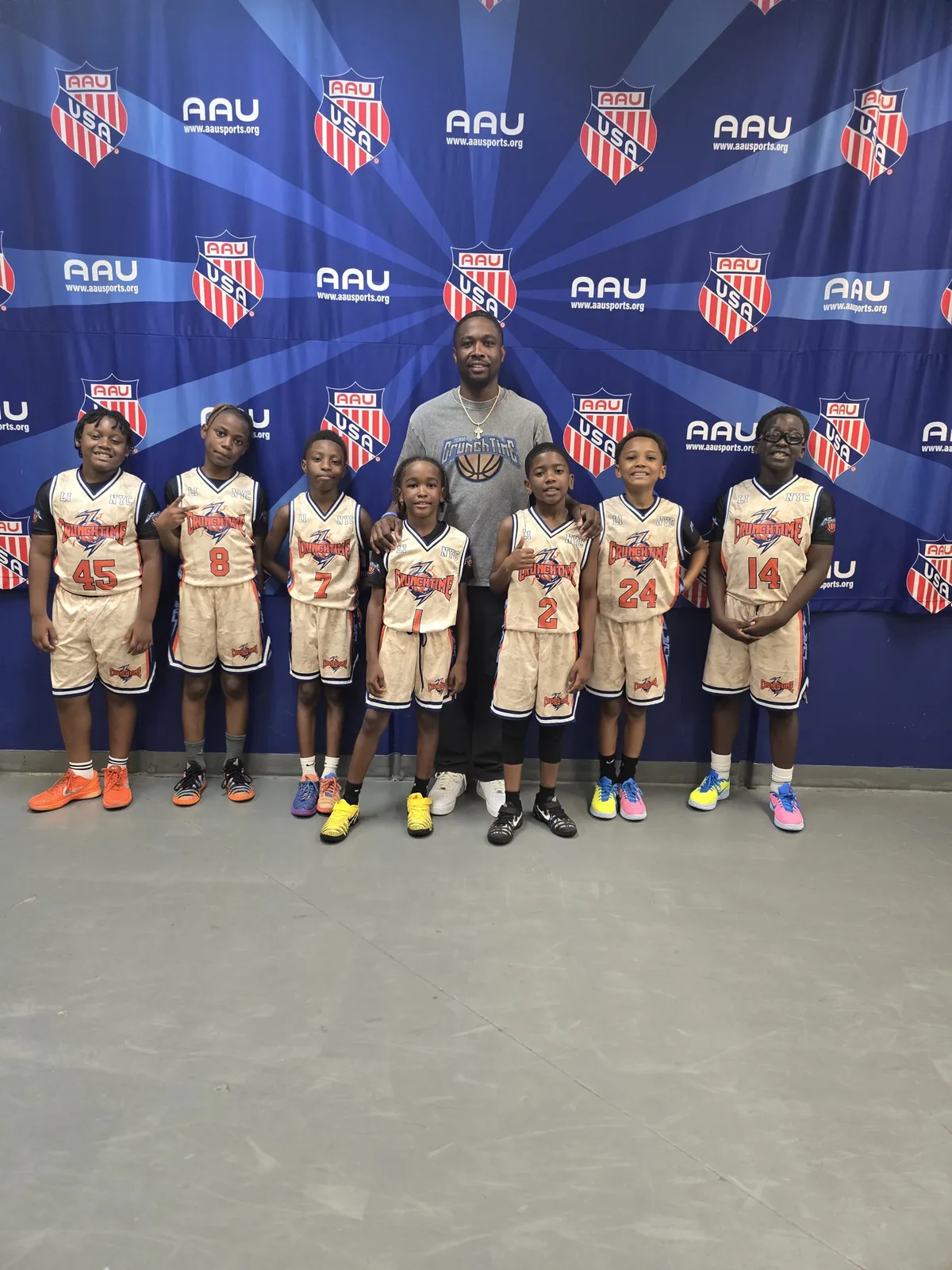 A Crunchtime team with their coach at an AAU tournament