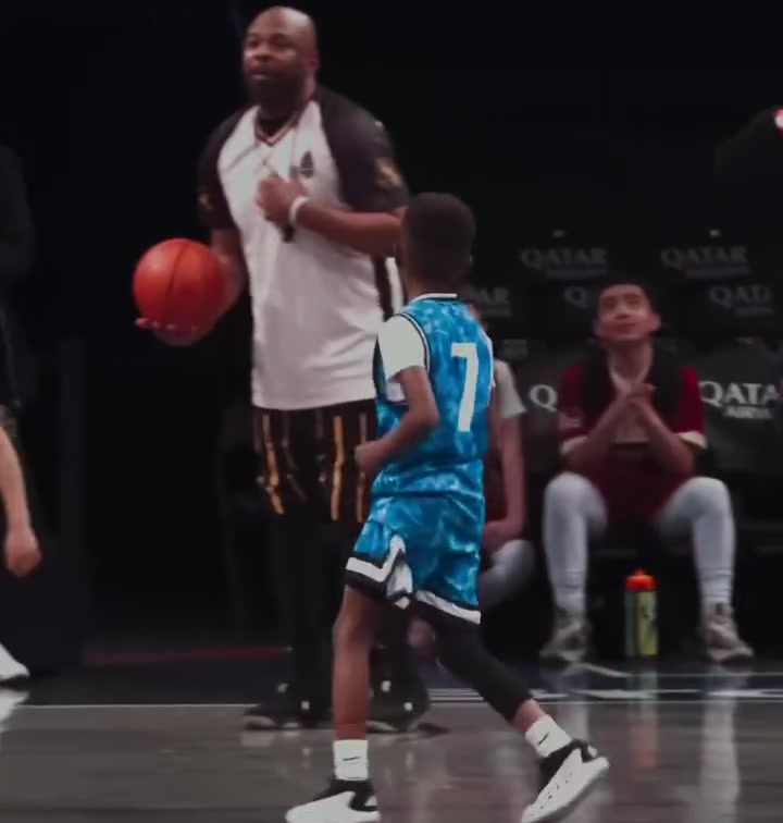 A coach working with a player on court